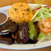 Costilla Asada/Grill Beef Ribs · served with salad, rice, fried bean two tortillas