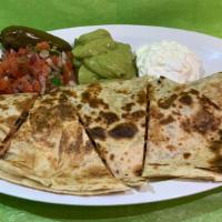 Quesadilla  · Soft flour tortilla filled with chicken or beef that includes melted cheese.