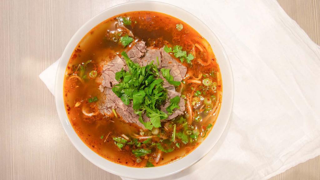 Spicy Beef Pho · This fusion is greatly admired for its balance of spicy, sour, salty and sweet flavors and the predominant flavor of lemon grass. Served in a huge bowl with slow cooked slices of tender Beef Brisket and thin cut strips of Beef Tripe. This is one of the most ordered bowl of Pho at our shops!