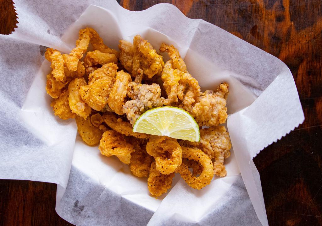 Calamari · Perfectly fried lightly battered calamari tossed ever so delicately in one of our signature dry rubs or sauces!