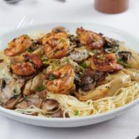 Cappellini Milano · Angel hair pasta, mushrooms, artichoke hearts and sauteed shrimp.
