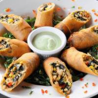 Tex-Mex Eggrolls · Stuffed with rotisserie chicken, black beans, Jack cheese, red peppers and onions - served w...