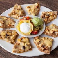 Mi-Tio Nachos · Nachos with refried beans, Chihuahua cheese and choice of fajita meat (8 pieces) - served wi...