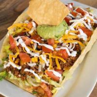 Taco Salad · Giant crispy taco shell stuffed with chopped lettuce, tomatoes, grated cheese, guacamole & s...
