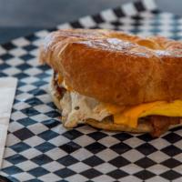 Croissant Sandwich · Choice of sausage bacon and brisket. served with egg potato and cheese.