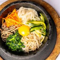 #58. Dolsot Bibimbap · Bibimbap with vegetables in a hot stone pot served with chili sauce