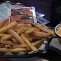 Basket Of Fries · A large basket of golden French fries.