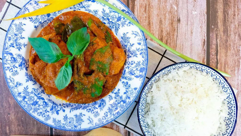 C4 Beef Panang Curry · House favorites slow cooked chucks of beef in hot and Spicy red Panang curry simmer in creamy coconut milk, serranos peppers and Thai basil. This curry is about level 3 spicy.