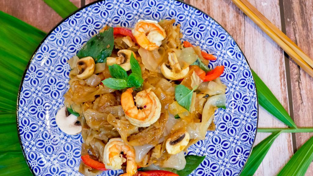 N3 Pad Kee Mao · When you need something to sober up, the name drunken noodles came from a story of a drunk guy trying to get home. This dish sobered him quick. Choice of Protein Flat noodle stir-fried with garlic, bell peppers, mushroom, Thai basil, and spicy chili paste. Spicy level 3.