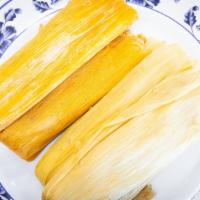 Tamales · Chicken or pork meat wrapped in corn husk.