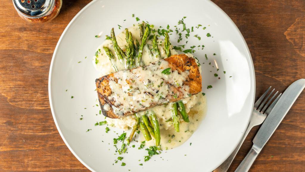 Grilled Salmon With Risotto · Grilled fillet of salmon topped garlic lemon pepper sauce,  served with parmesan risotto and sautéed asparagus.