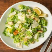 Caesar  · Romaine lettuce, croutons, shaved parmesan and Caesar dressing with side of lemons.