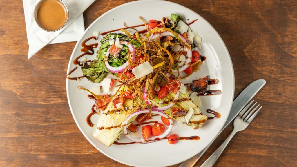 Grilled Romaine · Grilled romaine lettuce, sliced red onion, cherry tomatoes, cherrywood smoked bacon, crispy leeks, shaved parmesan, a side of balsamic dressing.