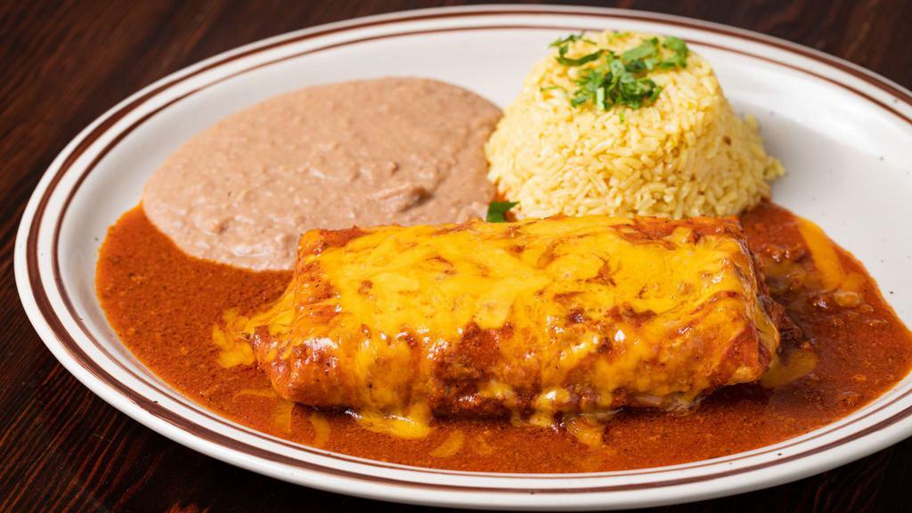 Chimichanga · Homemade flour tortilla stuffed with your choice of meat, deep fried, topped with beef gravy sauce and melted cheese. Comes with lettuce, tomatoes, guacamole, rice and beans on the side.
