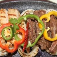 Our Famous Traditional Fajitas · Our famous fajita meat marinated in our secret recipe, grilled and cut to perfection then la...