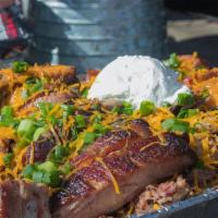 Roy Burns 10 Lb Potato · Served with chopped beef, ribs, butter, sour cream, cheese and chives. Choose your third mea...