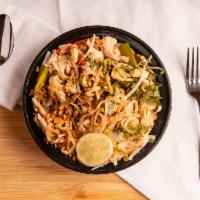 Pad Thai · Stir-fried thin rice noodles with egg, crushed peanut and scallion in sweet and tangy tamari...