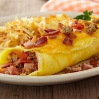 Texas Omelet · Stuffed with bacon, sausage, diced ham and American cheese, topped with cheddar and Monterey...