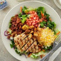 Chicken Club Salad · Tender boneless chicken breast (grilled or crispy) served on a bed of mixed greens with toma...