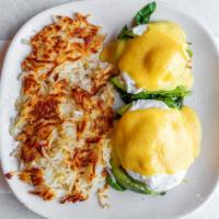 Eggs Benedict · Two poached eggs with canadian bacon on toasted english muffin. Topped with hollandaise sauc...