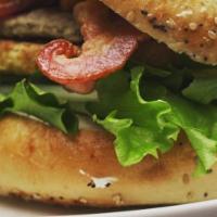 Bougie Bagel Burger · This Burger comes with cheddar cheese, mixed greens, sliced tomatoes, sliced onion, and our ...