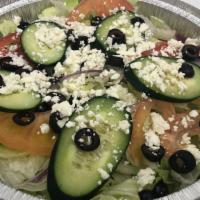 Greek Salad · Served with lettuce, tomatoes, cucumbers, onions, black olives, feta cheese, and choice of d...