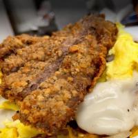 Rockwallian · Hashbrowns & onions, topped with cheddar cheese, biscuit, gravy  & homemade chicken fried st...