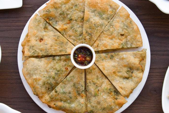 Green Onion Pie - Full Pie · Crispy, flaky, tender scallion pancakes served with chili soy sauce