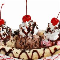 Banana Split · Three scoops of ice cream, a banana, whipped cream, chocolate syrup, sprinkles and cherries.