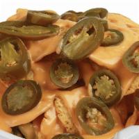 Nachos · Traditional Nacho Chips with nacho cheese sauce and jalapeños.