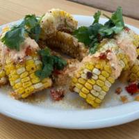 Sweet Corn Ribs · Sweet corn Ribs seasoned with chili spice, pepperonata, chili ranch, and parmesan