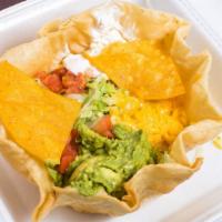 Taco Salad · A delicious beef or chicken salad. Served with lettuce, tomatoes, guacamole, sour cream, Mon...
