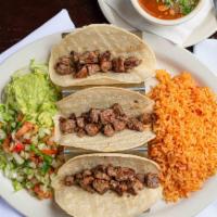 Ribeye Tacos · Three corn tortillas filled with diced ribeye steak. Served with rice, pico de gallo, guacam...