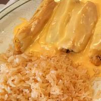 Tamale Combo · Four tamales covered with gravy and cheese. Served with rice and cheese puff.