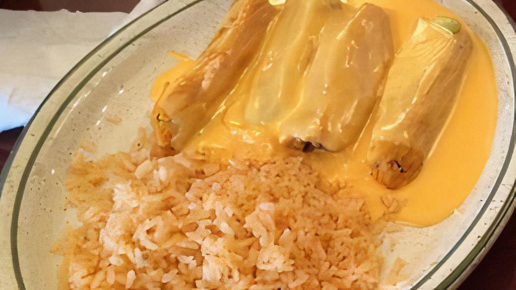 Tamale Combo · Four tamales covered with gravy and cheese. Served with rice and cheese puff.