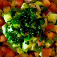 Shirazi Salad · Diced Persian Cucumber, Tomato, Red Onion, Parsley, and Lemon Juice Dressing.