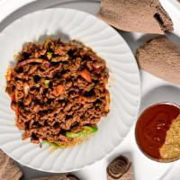 Awaze Tibs · Cubed tender beef marinated and cooked with tomato, jalapeño, garlic and berbere sauce.