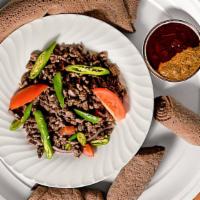 Beef Tibs · Tender, marinated pieces of beef cooked with green peppers, onion, garlic, tomato a touch of...