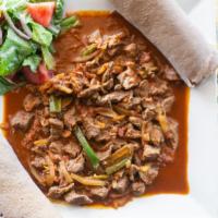 Tibs · Tender pieces of marinated beef, sautéed with onions, garlic, jalapeños, & fresh tomatoes se...