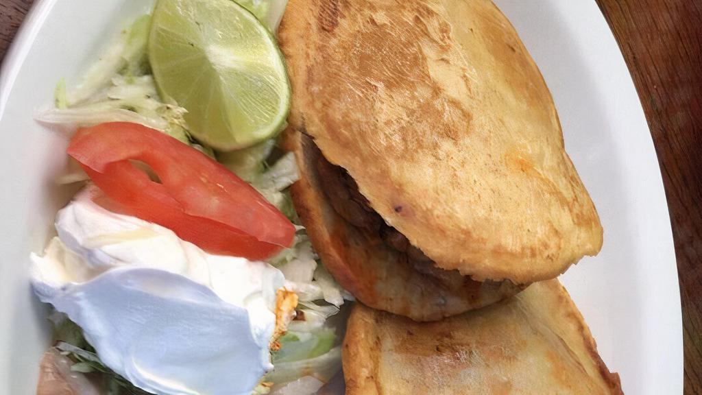 Gordita Plate · Two gorditas with rice, beans and salad.