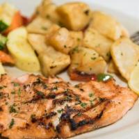 Salmon Dora · Grilled salmon filet topped with a lemon butter cream caper sauce - served with potato felix...