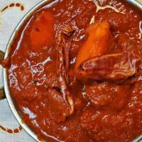 Lamb Vindaloo · Extra spiced lamb cooked with potatoes in a tangy, highly spiced sauce.