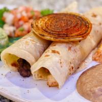 Tacos Al Carbon · Two flour tortillas filled with your choice of beef or chicken fajita served with rice, bean...