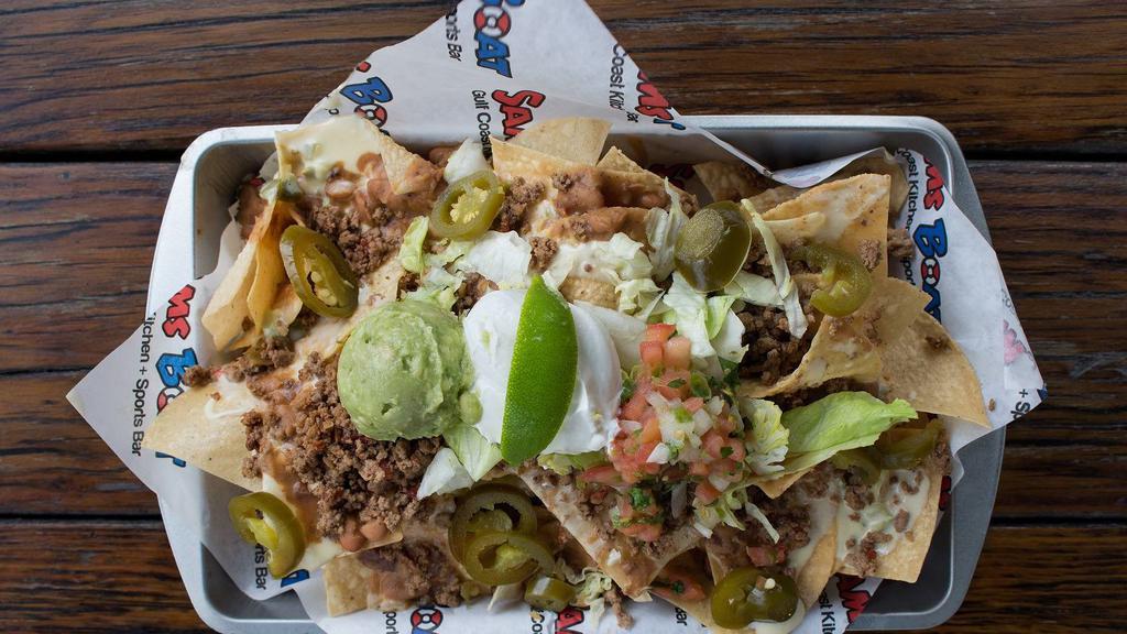 Mucho Nachos · Queso blanco, refried beans, pickled jalapenos, lettuce, guacamole, pico de gallo, sour cream, and choice of ground beef, chicken or combination. (Fajita Beef + $2.00)