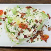 House Wedge Salad · Iceberg wedge, blue cheese dressing, blue cheese crumbles, bacon pieces, grape tomatoes, chive