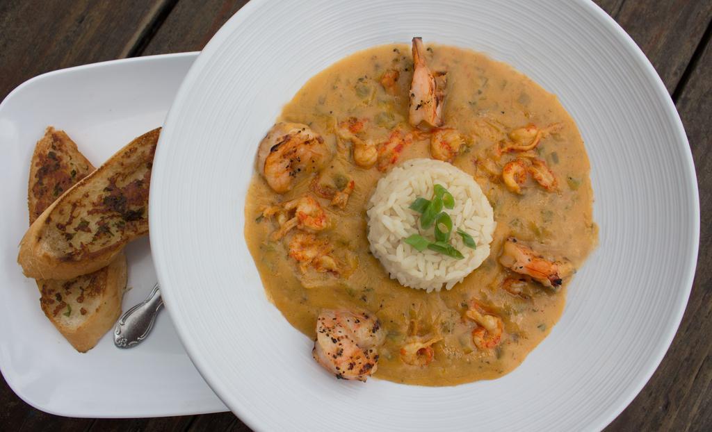 Shrimp + Crawfish Etoufee · Crawfish tails  + jumbo shrimp  smothered is a butter blend of onions peppers, celery, + garlic served over rice