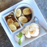 Bananas Foster Bread Pudding · Bread Pudding bites topped with caramelized bananas foster served with homemade vanilla ice ...