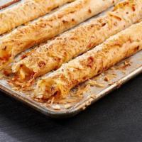 Pepperoni Piada Stick · Baked Piada dough with pepperoni, hand-rolled and served with creamy parmesan
