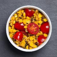 Sweet Corn Salad · Seasonal side with sweet corn, grape tomatoes, fresh basil, thyme, red onion, chili flake, p...