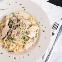 Chicken Carbonara · Sliced grilled chicken sautéed with peas, mushrooms, and pancetta in a sage alfredo cream sa...